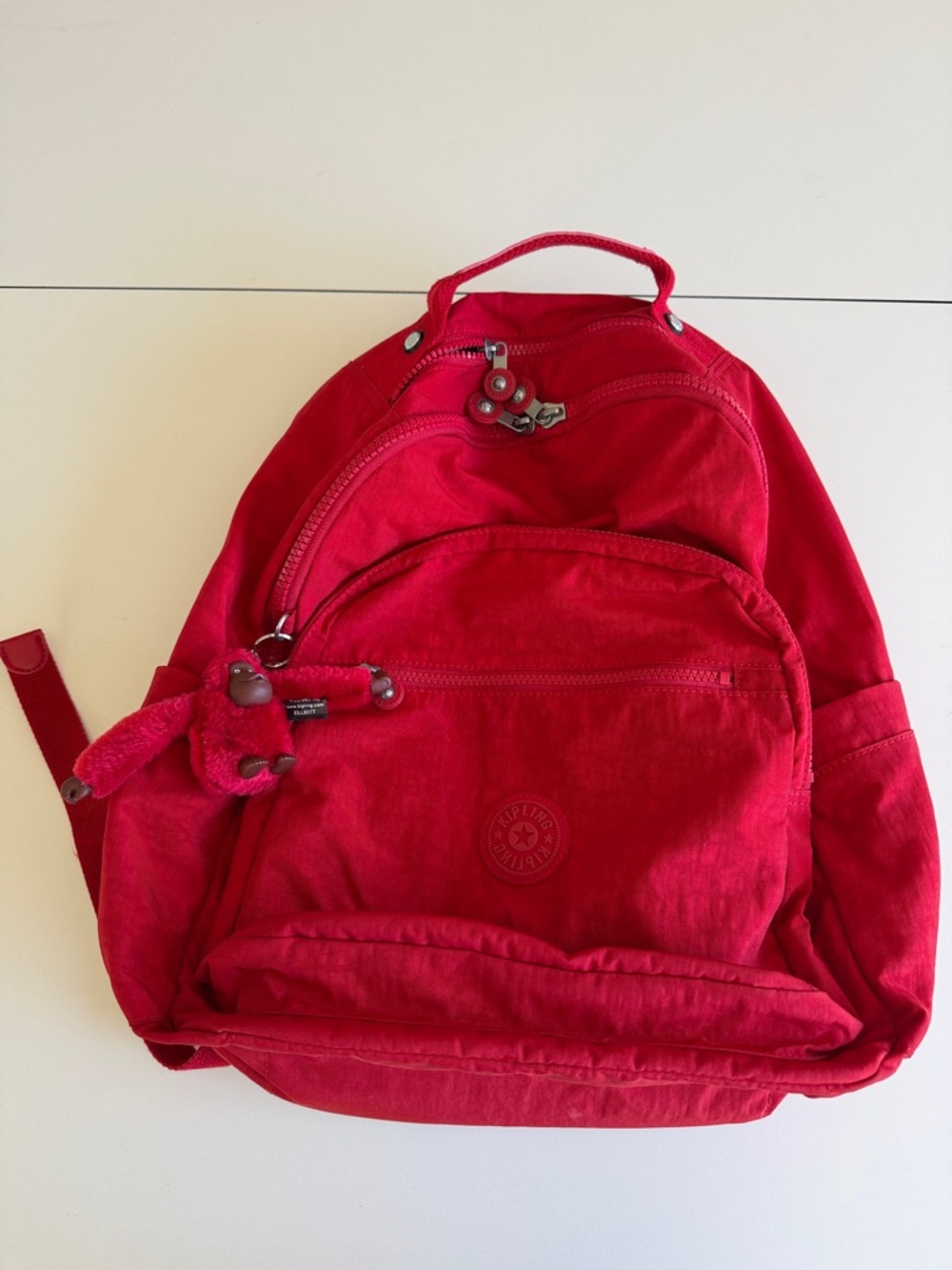 Kipling Vibrant Red Backpack with Monkey Charm